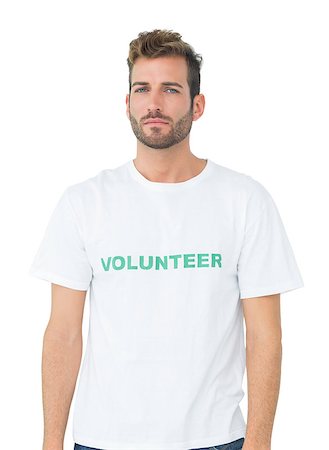 simsearch:400-07273307,k - Portrait of a serious young male volunteer standing over white background Stockbilder - Microstock & Abonnement, Bildnummer: 400-07273253