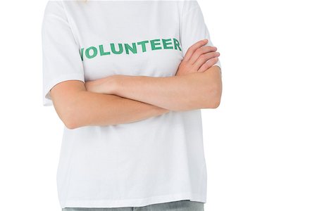simsearch:400-08575784,k - Mid section of a female volunteer standing with arms crossed over white background Stockbilder - Microstock & Abonnement, Bildnummer: 400-07273267
