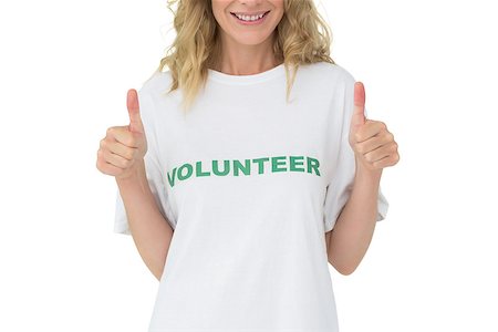 simsearch:400-07273307,k - Mid section of a happy female volunteer gesturing thumbs up over white background Stockbilder - Microstock & Abonnement, Bildnummer: 400-07273268