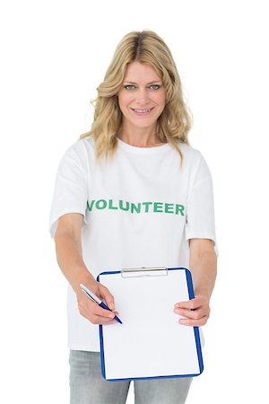 Portrait of a smiling young female volunteer holding clipboard over white background Stockbilder - Microstock & Abonnement, Bildnummer: 400-07273274