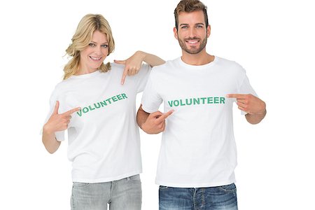 simsearch:400-07273325,k - Portrait of two happy volunteers pointing to themselves over white background Foto de stock - Royalty-Free Super Valor e Assinatura, Número: 400-07273285