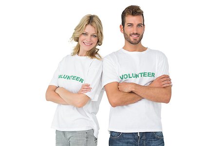 simsearch:400-07273325,k - Portrait of two happy volunteers standing with hands crossed over white background Foto de stock - Royalty-Free Super Valor e Assinatura, Número: 400-07273286