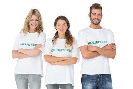 simsearch:400-07273325,k - Portrait of three happy volunteers standing with hands crossed over white background Foto de stock - Royalty-Free Super Valor e Assinatura, Número: 400-07273287