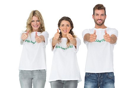 simsearch:400-07273325,k - Portrait of happy three volunteers gesturing thumbs up over white background Foto de stock - Royalty-Free Super Valor e Assinatura, Número: 400-07273288