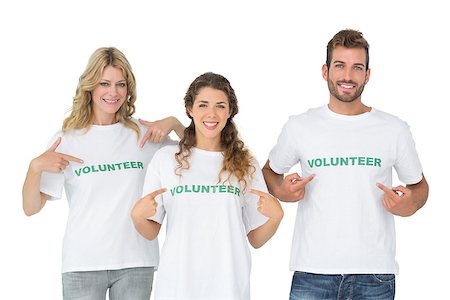 simsearch:400-07273325,k - Portrait of three happy volunteers pointing to themselves over white background Foto de stock - Royalty-Free Super Valor e Assinatura, Número: 400-07273289