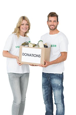simsearch:400-07273307,k - Smiling young couple carrying donation box over white background Stockbilder - Microstock & Abonnement, Bildnummer: 400-07273282