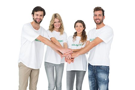 simsearch:400-07273325,k - Group portrait of happy volunteers with hands together over white background Foto de stock - Royalty-Free Super Valor e Assinatura, Número: 400-07273295