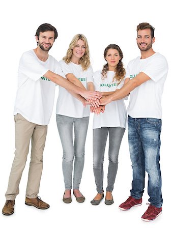 simsearch:400-07273325,k - Group portrait of happy volunteers with hands together over white background Foto de stock - Royalty-Free Super Valor e Assinatura, Número: 400-07273296
