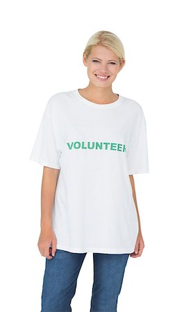 simsearch:400-08575784,k - Portrait of a smiling young female volunteer standing over white background Stockbilder - Microstock & Abonnement, Bildnummer: 400-07273301