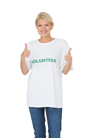 simsearch:400-07273307,k - Portrait of a happy female volunteer gesturing thumbs up over white background Stockbilder - Microstock & Abonnement, Bildnummer: 400-07273302