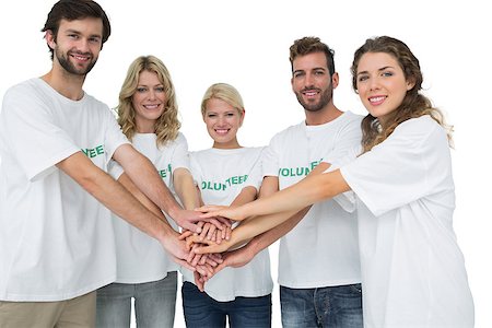 simsearch:400-07273307,k - Group portrait of happy volunteers with hands together over white background Stockbilder - Microstock & Abonnement, Bildnummer: 400-07273311
