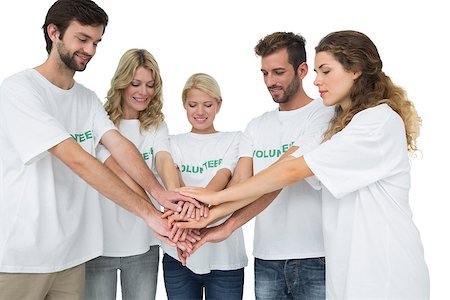 simsearch:400-07273325,k - Group of young volunteers with hands together over white background Foto de stock - Royalty-Free Super Valor e Assinatura, Número: 400-07273312