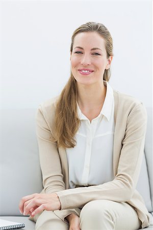 female advisor house - Portrait of a smiling female financial adviser sitting on sofa at home Stock Photo - Budget Royalty-Free & Subscription, Code: 400-07273359