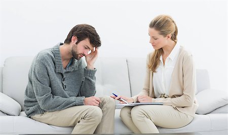 simsearch:400-07274690,k - Side view of a young man in meeting with a financial adviser at home Foto de stock - Super Valor sin royalties y Suscripción, Código: 400-07273362