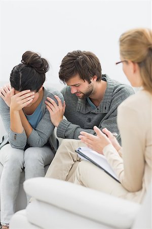 serious counselor talking with person - Displeased young couple in meeting with a financial adviser at home Stock Photo - Budget Royalty-Free & Subscription, Code: 400-07273395