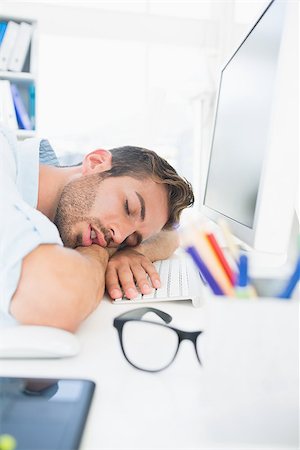 simsearch:400-07466593,k - Side view of a male artist with head resting on keyboard in the office Stock Photo - Budget Royalty-Free & Subscription, Code: 400-07273528