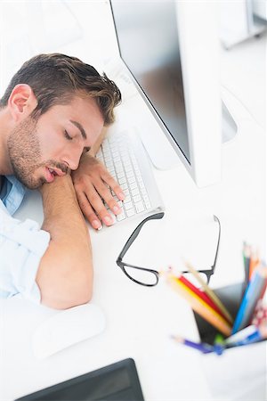 simsearch:400-07466593,k - Side view of a male artist with head resting on keyboard in the office Stock Photo - Budget Royalty-Free & Subscription, Code: 400-07273529
