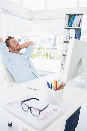Relaxed casual young man resting with hands behind head in a bright office Stock Photo - Budget Royalty-Free & Subscription, Code: 400-07273534