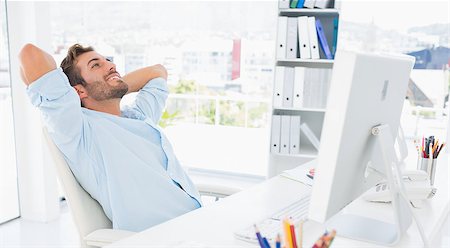 Relaxed casual young man resting with hands behind head in a bright office Stock Photo - Budget Royalty-Free & Subscription, Code: 400-07273535