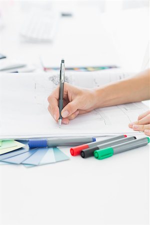 editor (female) - Closeup side view of an artist drawing something on paper with pen at the office Stock Photo - Budget Royalty-Free & Subscription, Code: 400-07273900