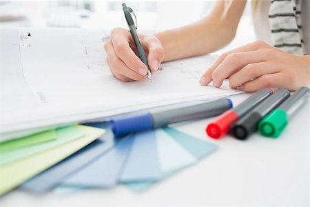 editor (female) - Extreme closeup of an artist drawing something on paper with pen at the office Stock Photo - Budget Royalty-Free & Subscription, Code: 400-07273901