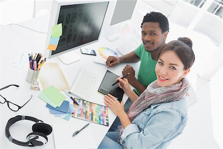 High angle portrait of an artist with colleague drawing something on graphic tablet at the office Photographie de stock - Aubaine LD & Abonnement, Code: 400-07273929