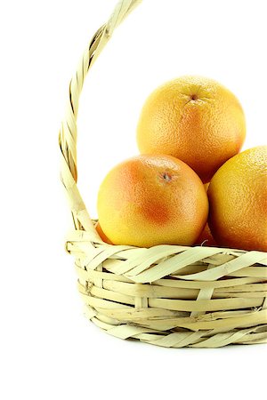 Ripe appetizing grapefruit in straw basket . Stock Photo - Budget Royalty-Free & Subscription, Code: 400-07289336