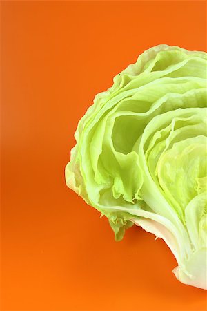 simsearch:400-05369257,k - Fresh Green Iceberg lettuce on orange background . Photographie de stock - Aubaine LD & Abonnement, Code: 400-07289648