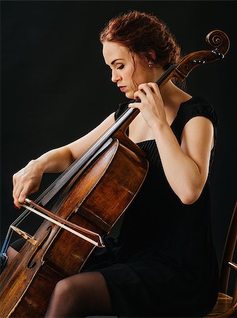 Photo of a beautiful woman playing an old cello. Stockbilder - Microstock & Abonnement, Bildnummer: 400-07294057