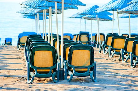 simsearch:400-06947087,k - chairs stand in a row under blue umbrellas Stock Photo - Budget Royalty-Free & Subscription, Code: 400-07294085