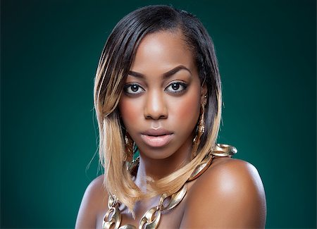 simsearch:400-07292674,k - Attractive black woman wearing a golden necklace Photographie de stock - Aubaine LD & Abonnement, Code: 400-07294471