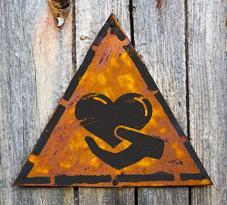 Charity. Icon of Heart in the Hand on Weathered Triangular Yellow Warning Sign. Grange Background. Stock Photo - Budget Royalty-Free & Subscription, Code: 400-07294544
