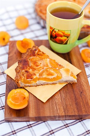 simsearch:400-04709493,k - Piece of apricot tart on the wooden board with cup of tea and fresh apricots around Stock Photo - Budget Royalty-Free & Subscription, Code: 400-07295671