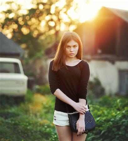 Young woman posing against old car Stock Photo - Budget Royalty-Free & Subscription, Code: 400-07295996