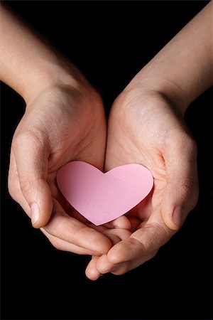 simsearch:400-05701644,k - female teen hands holding heart paper, isolated on black Stock Photo - Budget Royalty-Free & Subscription, Code: 400-07296291