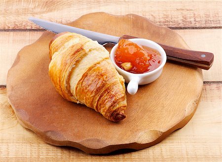 simsearch:400-07420117,k - Freshly Baked Croissant with Apricot Jam and Table Knife on Wooden Plate closeup on Rustic Wooden background Stock Photo - Budget Royalty-Free & Subscription, Code: 400-07298256