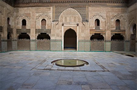 door in the medina - Ornate carving on the plastered walls and on the woodwork in the courtyard of the historic Madrasa Bou Inania in the ancient medina of Fes in Morocco Stock Photo - Budget Royalty-Free & Subscription, Code: 400-07298409