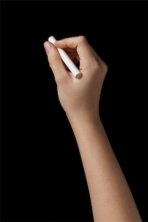 female teen hand with chalk to write something, isolated on black Stock Photo - Budget Royalty-Free & Subscription, Code: 400-07298809