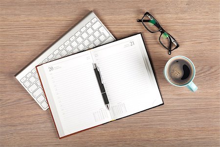 Blank notepad and coffee cup on office wooden table Stock Photo - Budget Royalty-Free & Subscription, Code: 400-07299260