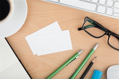 Blank business cards with supplies and coffee cup on wooden office table Stock Photo - Budget Royalty-Free & Subscription, Code: 400-07299288