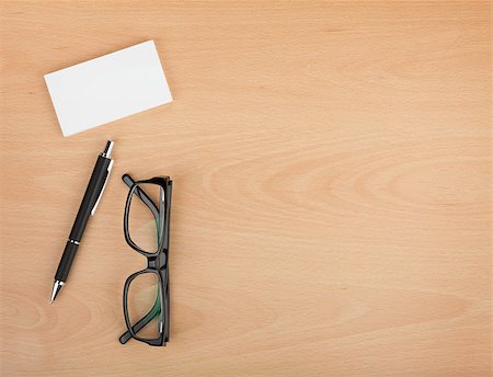 Blank business cards with pen and glasses on wooden office table with copy space Stock Photo - Budget Royalty-Free & Subscription, Code: 400-07299289
