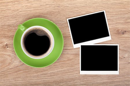 simsearch:400-07179655,k - Cup of coffee and two photo frames on wooden table Foto de stock - Super Valor sin royalties y Suscripción, Código: 400-07299392