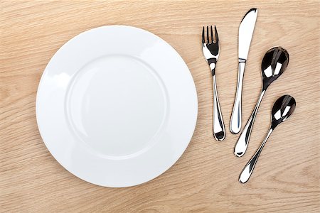 simsearch:400-07331603,k - Empty white plate with silverware on wooden table. View from above Foto de stock - Super Valor sin royalties y Suscripción, Código: 400-07299422