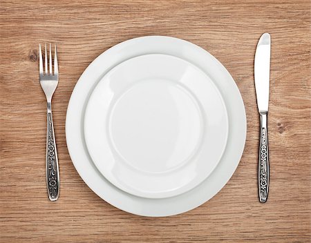 plate space - Empty plate and silverware set on wooden table Foto de stock - Super Valor sin royalties y Suscripción, Código: 400-07299507