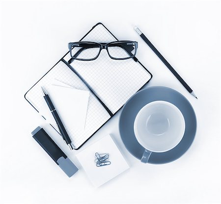 simsearch:400-04699017,k - Coffee cup and office supplies. View from above. Blue toned Photographie de stock - Aubaine LD & Abonnement, Code: 400-07299518