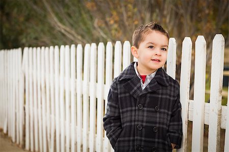 racing fences - Young Mixed Race Boy Waiting For Schoold Bus Along Fence Outside. Stock Photo - Budget Royalty-Free & Subscription, Code: 400-07299984