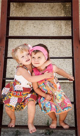 two little girls sitting on stairs hugging barefoot outside Stock Photo - Budget Royalty-Free & Subscription, Code: 400-07290707