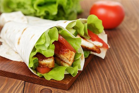 wheat tortilla with chicken and vegetables on wood board Stock Photo - Budget Royalty-Free & Subscription, Code: 400-07291374