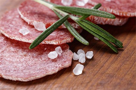 dry cured - italian salami sausage slices with rosemary and sea salt, wood board Stock Photo - Budget Royalty-Free & Subscription, Code: 400-07291392