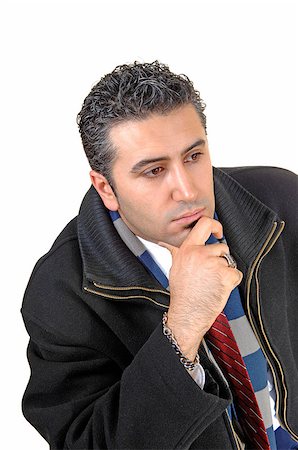 simsearch:400-04485729,k - A good looking young businessman in a black coat and red tie with his hand on his chin looking ahead and thinking. Stock Photo - Budget Royalty-Free & Subscription, Code: 400-07291410